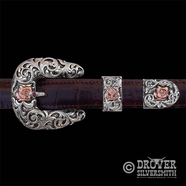 Crafted with precision and passion,  The Homesteader Sterling Silver Belt features a solid rustic charm with a hand engraved base and copper flowers in the buckle, tool and tip. Add a second loop for a ranger buckle set now!